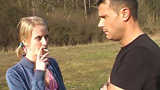 Fresh faced blond amateur gives a blowjob to horny dude outdoors