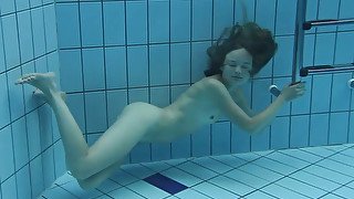 Petite and beautiful girl in sexy bikini under water