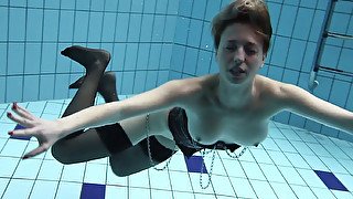 Hot pale skin gingerhead girl in stockings underwater