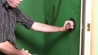 White dude sucks big black cock in a glory hole video