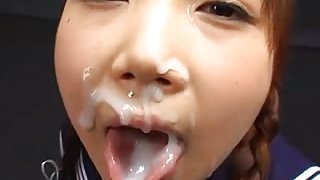 Smiling Japanese girls kiss and swap cum while getting facials