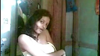 Cute curly haired Desi gal flashed her tits while stripping on camera