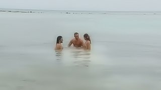 Sensual threesome sex on the beach with two angels