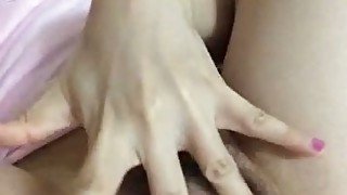 Tempting Asian GF fondling hairy pussy in amateur sex video