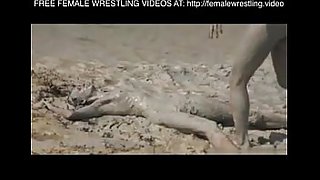 Girls wrestling in the mud