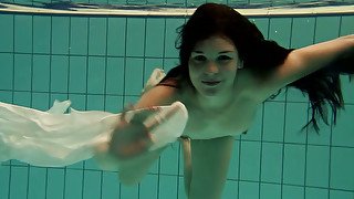 Lascivious brunette European babe loosens her buttons under water