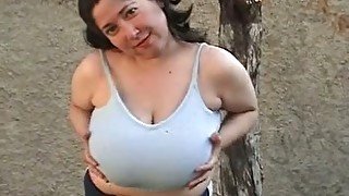 Chubby brunette milf plays with her big natural tits outdoors