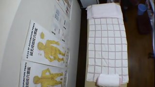 A girl gets some pussy and tits massage in the medical room.