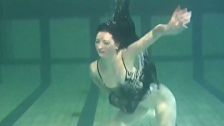 Adorable brunette Russian teen underwater in her dress