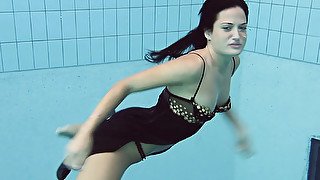 Pure dark brunette beauty underwater in the pool on cam