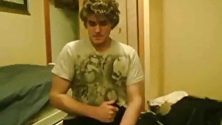 Young cutie with curly hair strokes his boner