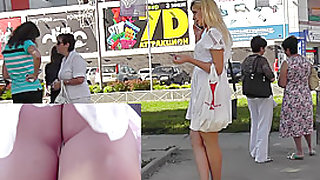 Sexy blonde in white dress lures up skirt camera