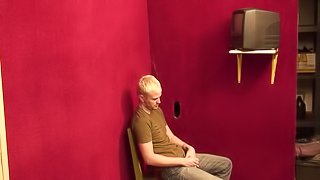 Horny blonde gay guy sucks the dick through a gloryhole