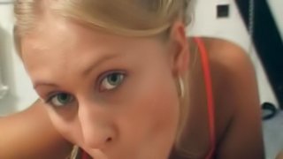 A blonde crawls across the floor and sucks her man's cock